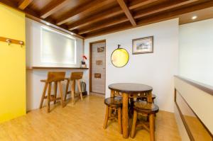 a kitchen with a table and stools in a room at Xiangyang No 2 B&B in Wujie