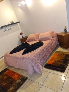 a bedroom with a bed and two rugs on the floor at Casa da Oliveira in Pegarinhos