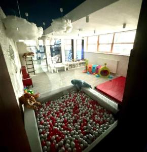 a room with a pool of balls in the floor at Apartament Whiteblue Dream 2 Kołobrzeg z ogródkiem & sauna & fitness & bawialnia dla dzieci in Kołobrzeg