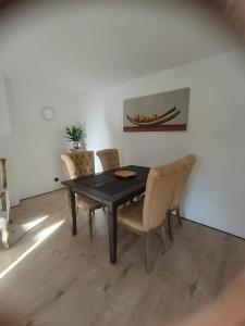 a dining room with a black table and chairs at Haus am Wanderweg in Niederdürenbach