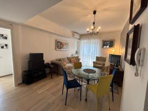 a living room with a table and a couch at Lakehouse Enjoy in Verbania