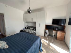 a bedroom with a bed and a flat screen tv at Lakehouse Enjoy in Verbania