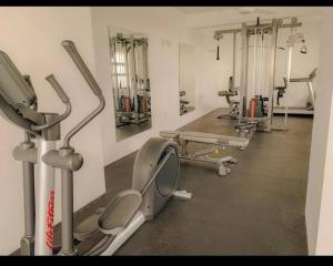 a gym with several treadmills and machines at Luxe Beach Pad in Wattala