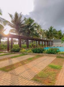a resort with palm trees and a swimming pool at Luxe Beach Pad in Wattala