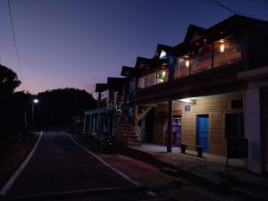 an empty street with a building at night at Nature Valley Homestay Shaukiyathal in Panuānaula