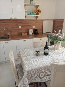 uma cozinha com uma mesa e uma garrafa de vinho em Apartment Silvana em Sibenik