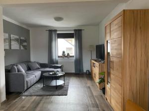 a living room with a couch and a table at Ferienwohnung Burgberg in Stadtkyll