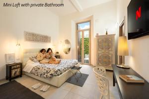 Due donne sedute su un letto in una camera da letto di APARTMENT 20 a Firenze