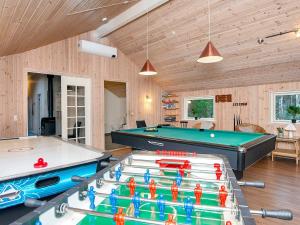 a room with a pool table and ping pong tables at 12 person holiday home in R m in Bolilmark