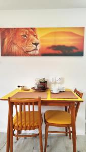 a table with a lion picture on the wall at Apartmán tiny house v prírode 