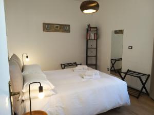 a bedroom with a white bed with two pillows at La Porta dei Mori in Palermo