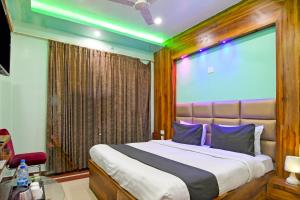 a bedroom with a large bed with a large window at Hotel Ashray Near Temple & Beach By Morservices in Puri