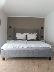 a bed with white sheets and pillows in a bedroom at Haus am Wanderweg in Niederdürenbach