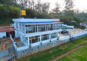a building under construction next to a road at Silent Retreat Ooty Farm Resort by VOYE HOMES in Ooty