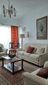a living room with a couch and a coffee table at Casa das Floreiras - City Center Apartment in Horta