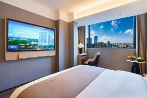広州市にあるLanou Hotel Guangzhouの大画面テレビが備わる客室です。