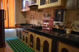 a kitchen with a pink appliance on a counter at Lotus cottage in Manāli