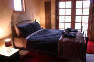 A bed or beds in a room at La Boheme Villa