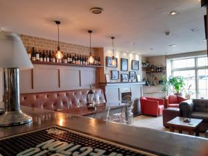 a bar in a restaurant with a couch and chairs at Browns Hotel in Dartmouth