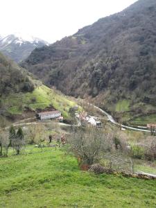 a view of a mountain with a train on a road at OSO3 in Pola de Somiedo