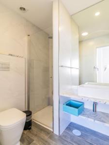 a bathroom with a shower and a toilet and a sink at Charming Boavista Apartment by Unique Hosts in Porto