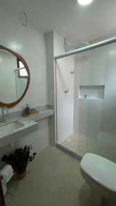 ein Bad mit einer Dusche, einem WC und einem Spiegel in der Unterkunft Apto JP 301 para 2 pessoas in Vitória