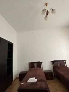 a bedroom with two beds and a ceiling at Guest House - Tbilisi Center in Tbilisi City