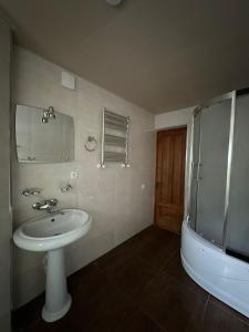 a bathroom with a sink and a shower at Guest House - Tbilisi Center in Tbilisi City