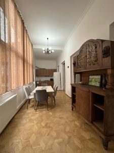 a dining room with a table and chairs and a kitchen at Guest House - Tbilisi Center in Tbilisi City