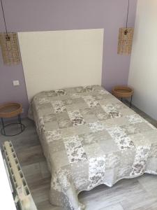 a bed in a room with two stools next to it at Le studio D'auguste- Cœur de Nîmes-chaleureux-emplacement idéal in Nîmes