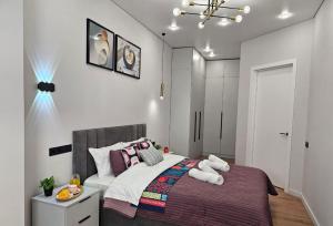 a bedroom with a large bed in a room at ЖК Комфорт Сити Бизнес, 2 room Apartment 47 in Almaty