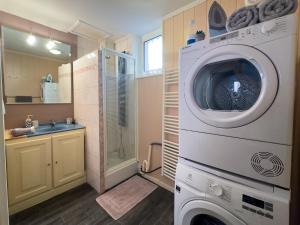 a washing machine in a bathroom with a sink at ART appartement climatisé, 3 chambres, 5 lits, 1 min du port, cuisine équipée and jeux de société in Port-Vendres