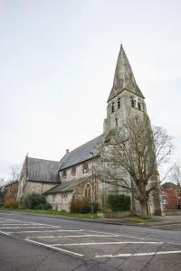 an old church with a steeple on the side of a street at Spire View Apartment*SO15 Sleeps 4-Secure Parking in Southampton