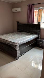 a large bed sitting in the corner of a room at Berakah cozy Rentals in Freetown