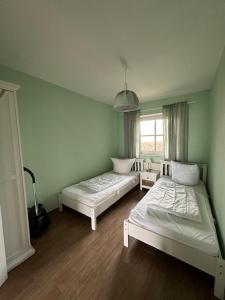 En eller flere senge i et værelse på Jacobihof Haus 7 Wohnung 02