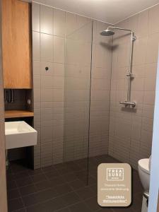 a bathroom with a shower and a toilet and a sink at Default steph in Vienna