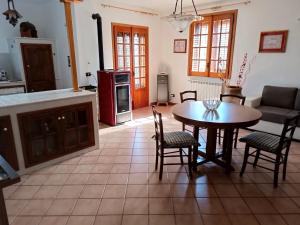 a kitchen and dining room with a table and chairs at Casa Belvedere in Isnello