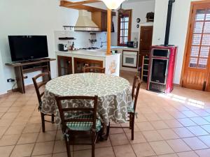 a kitchen with a table and chairs and a stove at Casa Belvedere in Isnello