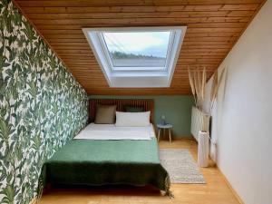 a bedroom with a bed with a large window at bei Servays in Eppingen