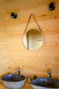 a bathroom with two sinks and a mirror at Le Domaine de La Tour des Vents in Bergerac