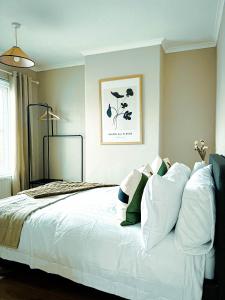 a bedroom with a large bed with white pillows at The Grange in Stockton-on-Tees
