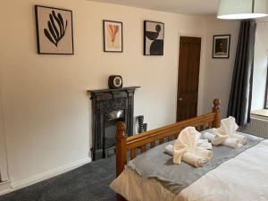a bedroom with a bed with white pillows on it at Stunning Cottage with Log Burner in Frosterley