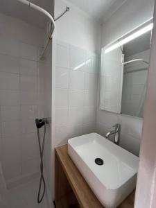 a white bathroom with a sink and a mirror at Plein Sud By Bellavista - 400 m de la plage - terrasse - parking in Argelès-sur-Mer +19 photos