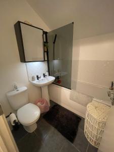 a bathroom with a toilet and a sink at Cosy Double Room in Dartford