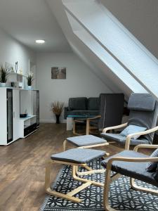a living room with two chairs and a couch at Inselloft-Fehmarn in Fehmarn