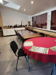a room with tables and chairs and a kitchen at Gite le Nid de l'Erdre in La Pouëze +27 photos