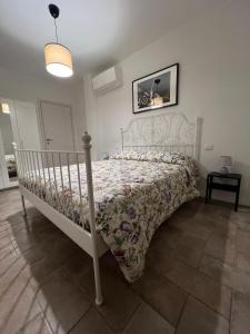 a bedroom with a white bed with a comforter at Casa sul Conca in San Giovanni in Marignano