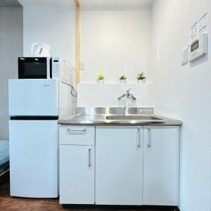 a kitchen with a sink and a refrigerator at 【三米通天閣】302-3FB難波商圈天王寺心斎橋10min in Osaka