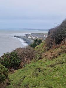 a view of the ocean from a hill at Harries Lodge 2 Aberaeron in Aberaeron