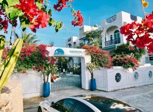 a car parked in front of a building with flowers at Santorini Villa Cam Ranh in Cam Ranh
